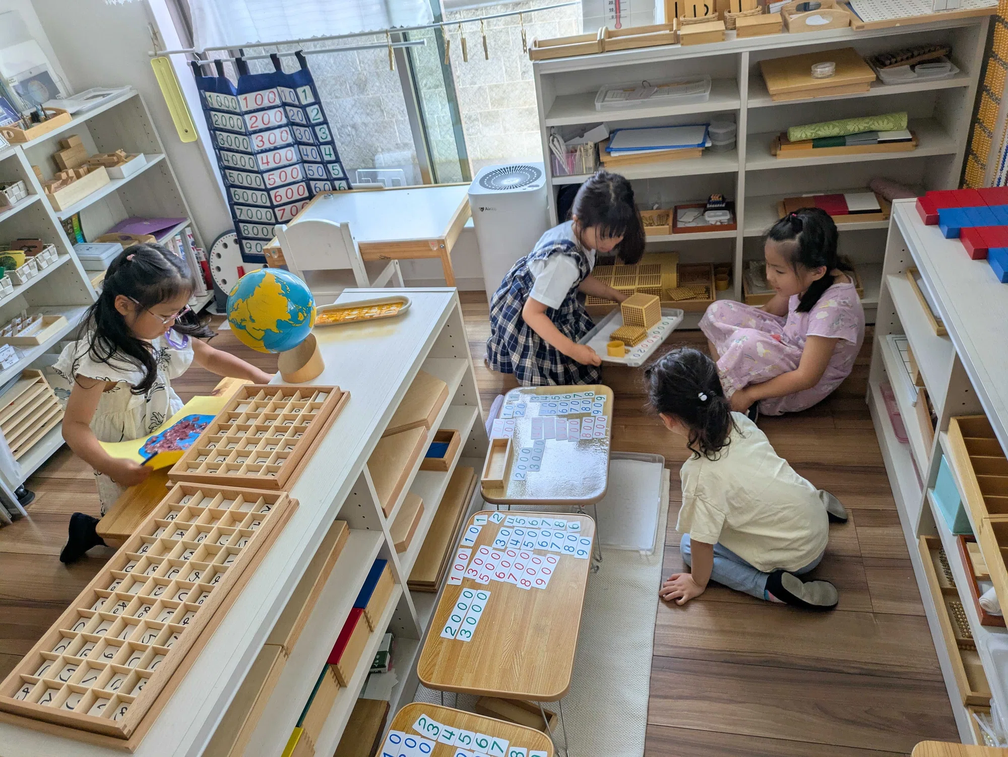 Children working with Montessori materials